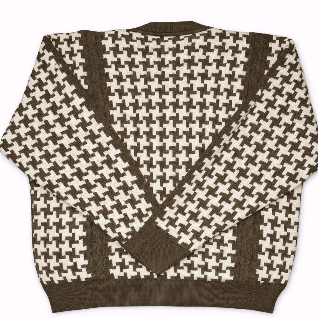 Brown and white houndstooth patterned sweater on a white background