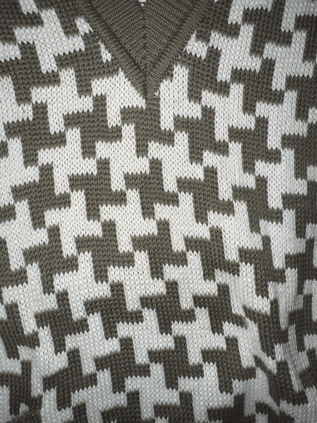 Close-up of a houndstooth pattern fabric in black and white.