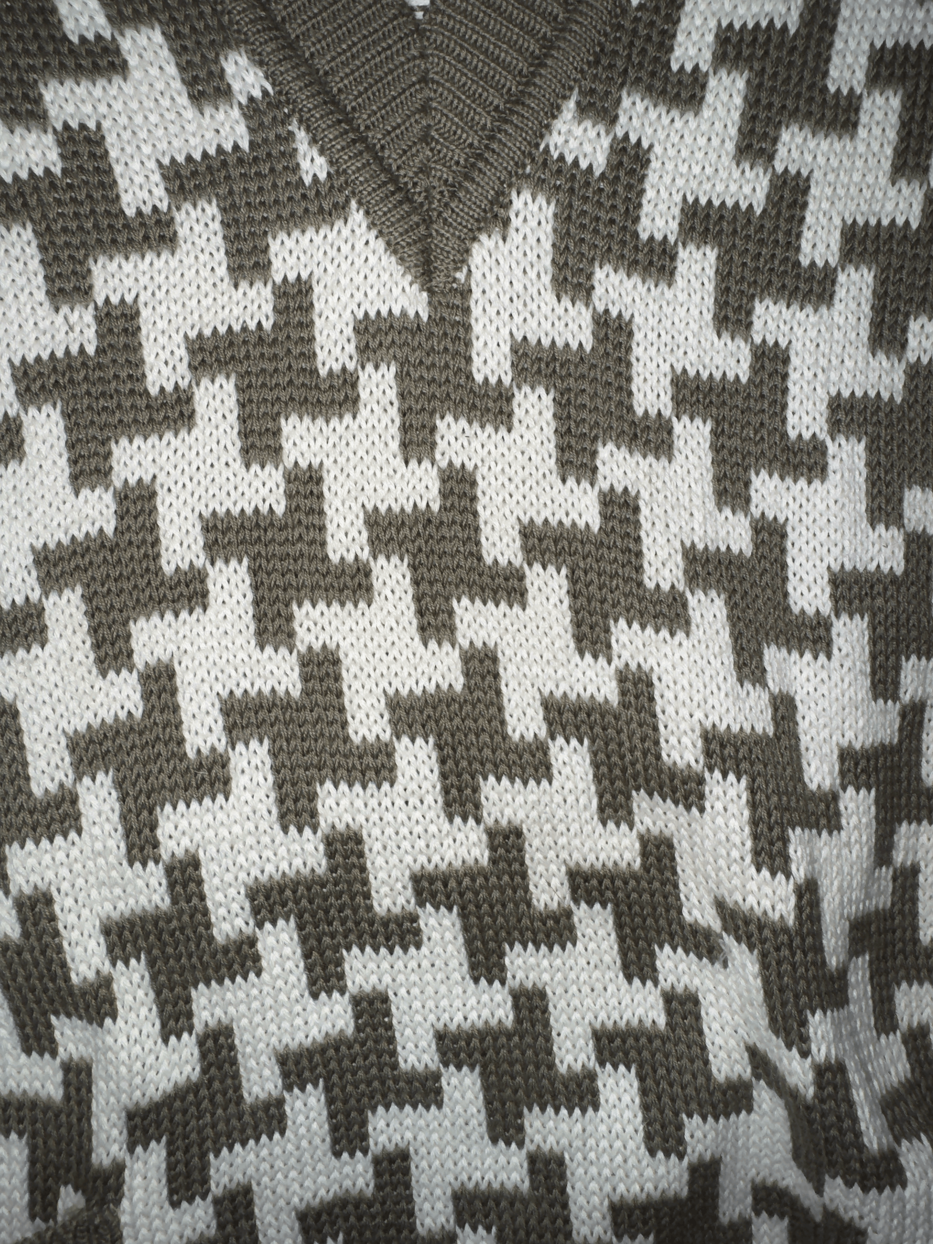 Close-up of a houndstooth pattern fabric in black and white.