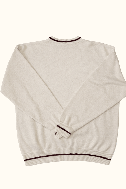 White sweater with black trim on a white background