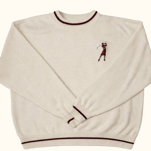 Beige sweater with a golf-themed design on a white background