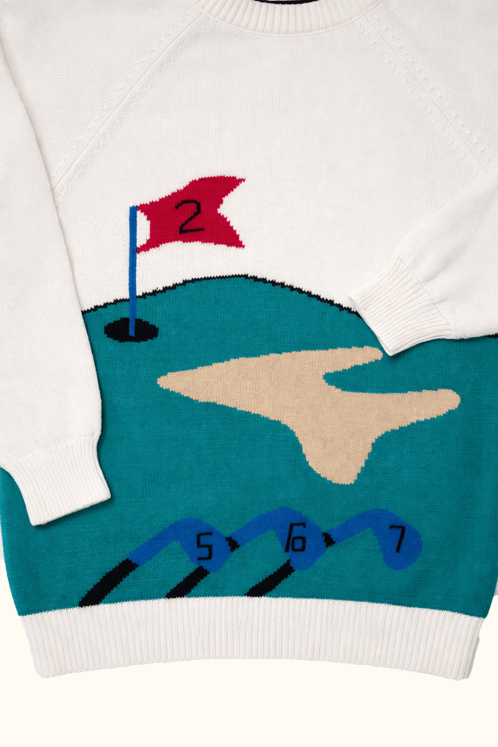 Sweater with golf course design featuring a flag and numbers.