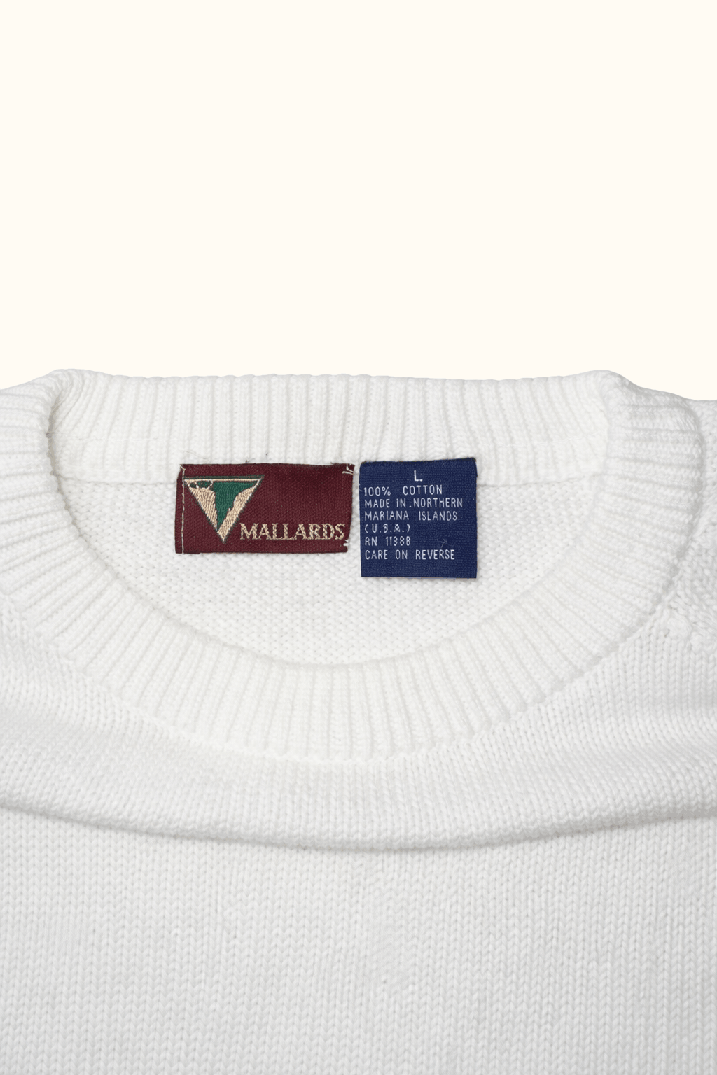 White sweater with Mallards brand labels on a white background