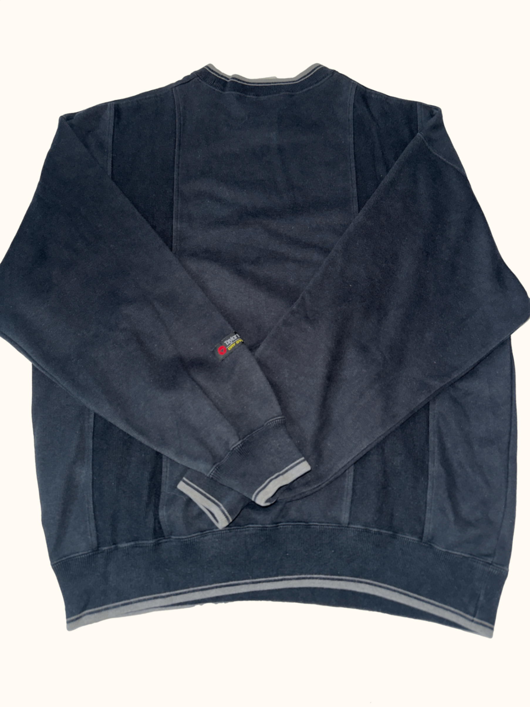 black sweatshirt with 'Taylor Made' logo on a white background
