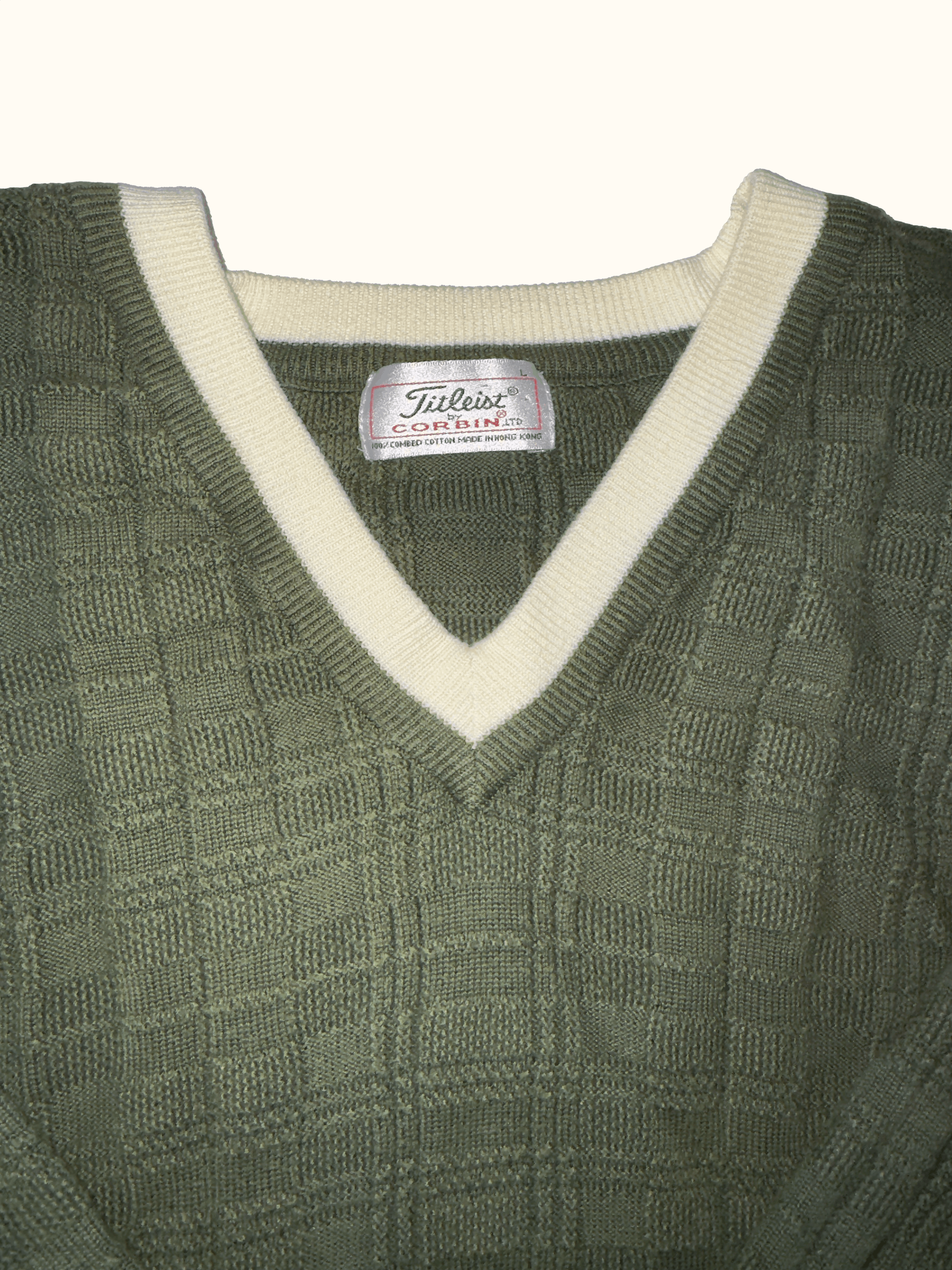 Green sweater with a white collar and Titleist logo on a white background