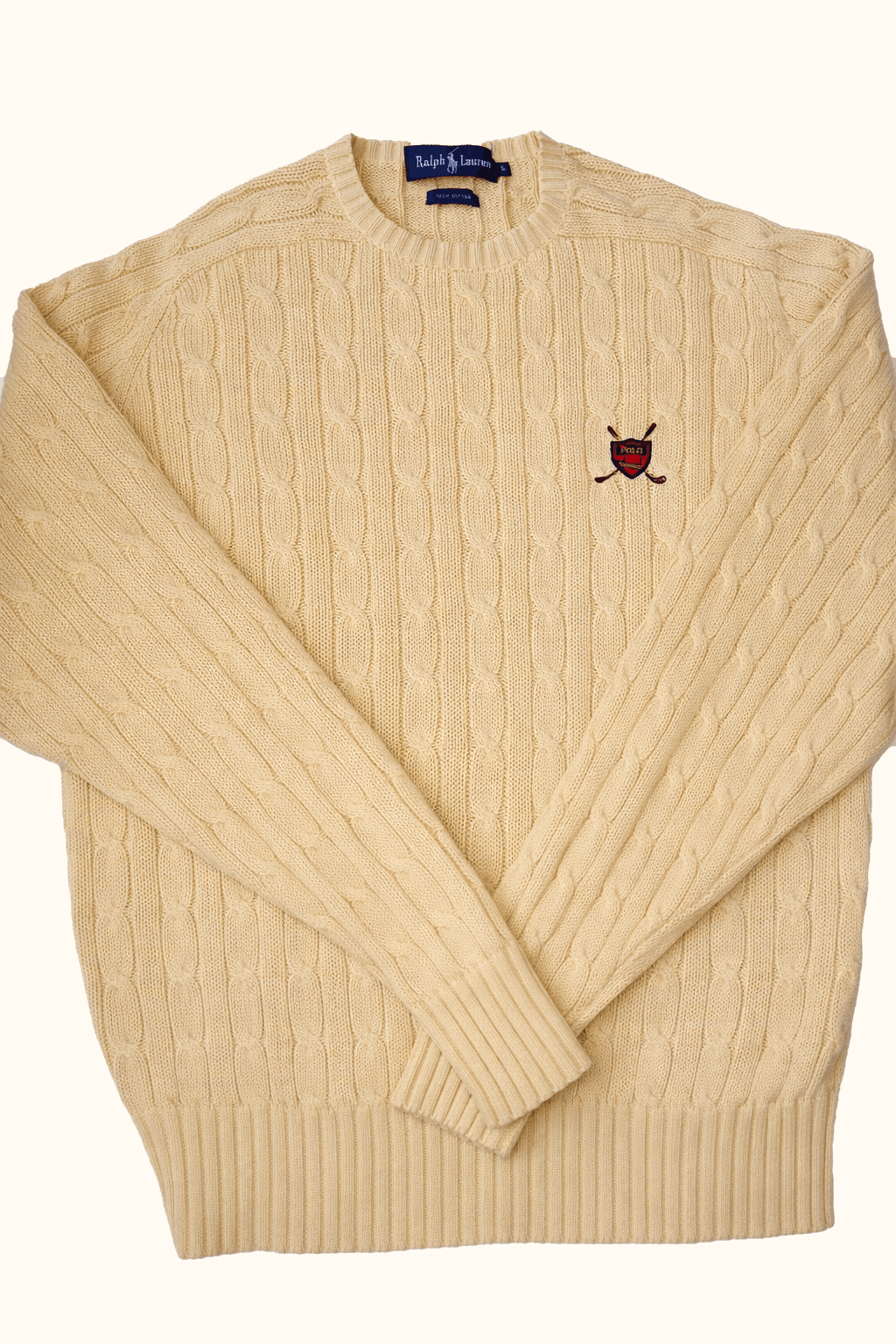 Beige sweater with a brand logo on a white background