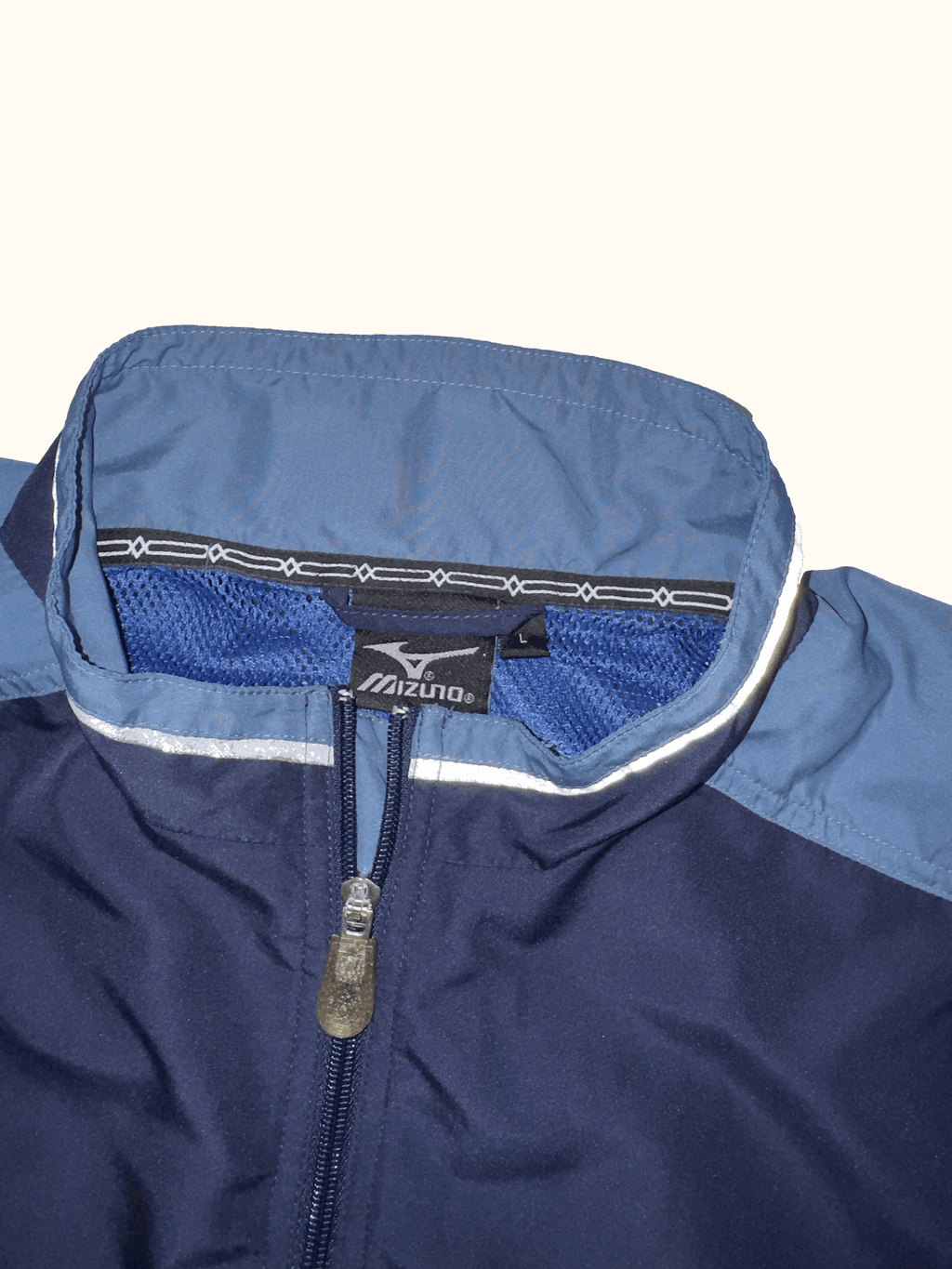 Navy blue jacket with a mizen logo on a white background