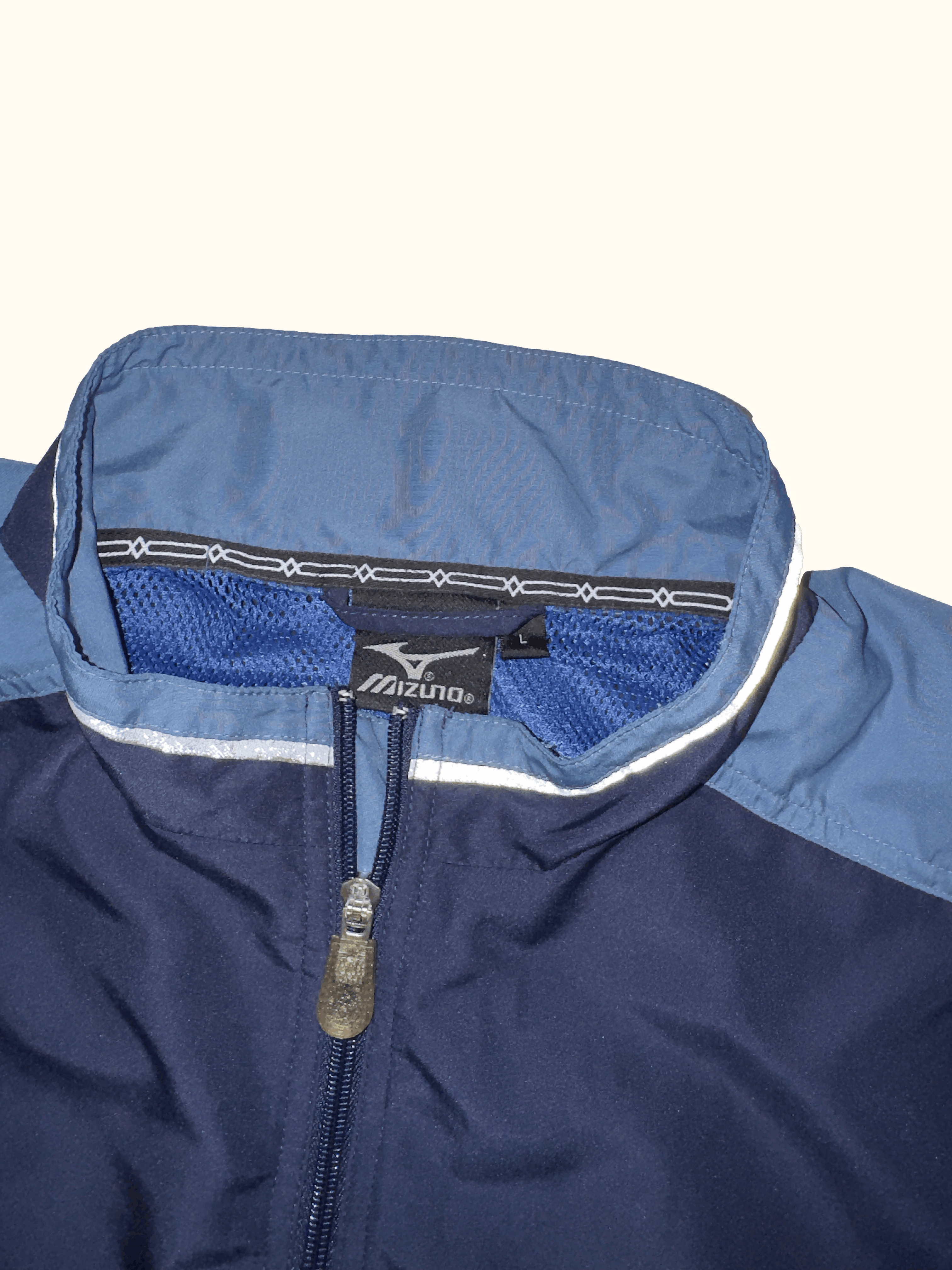 Navy blue jacket with a mizen logo on a white background