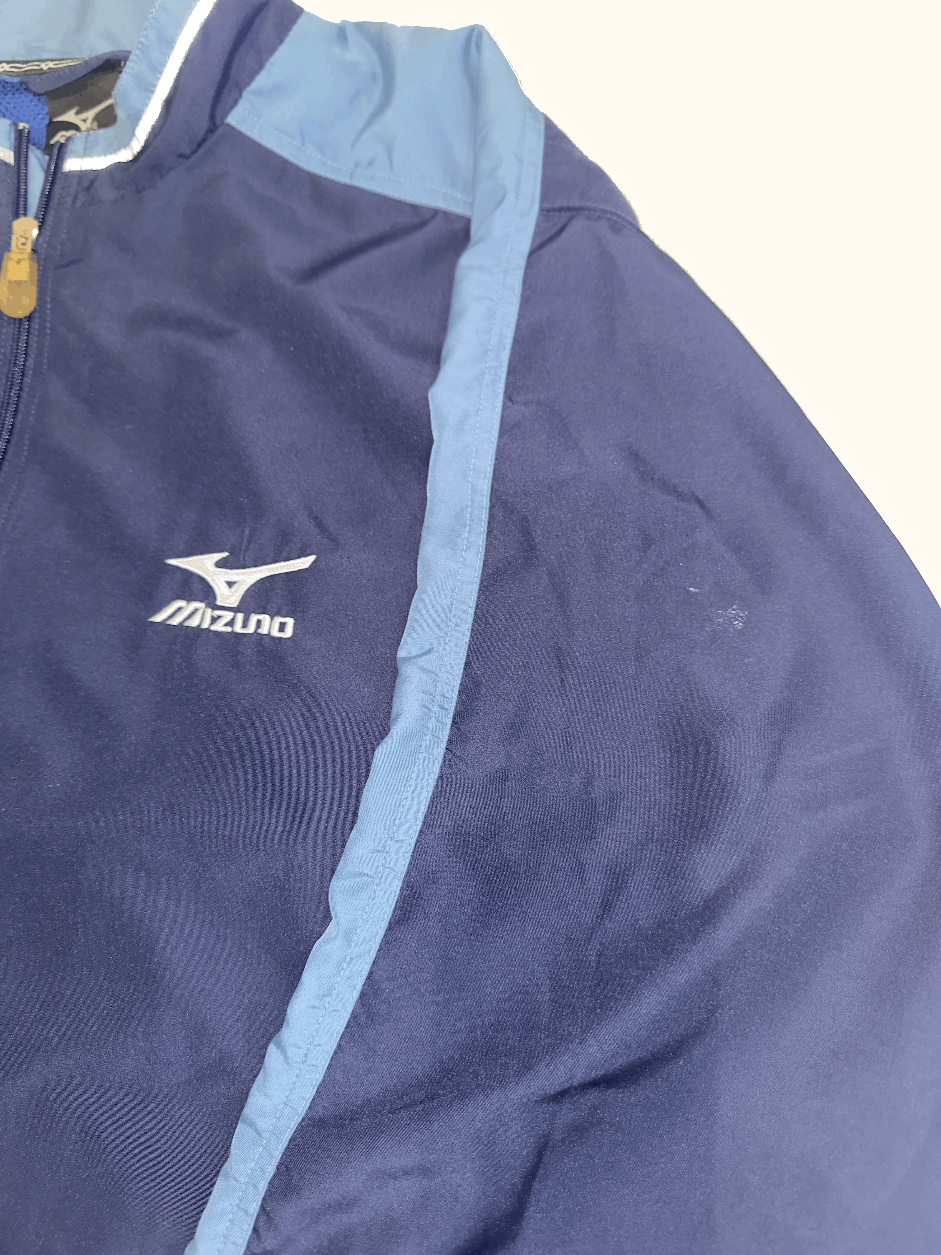Navy blue jacket with Mizuno logo on a white background