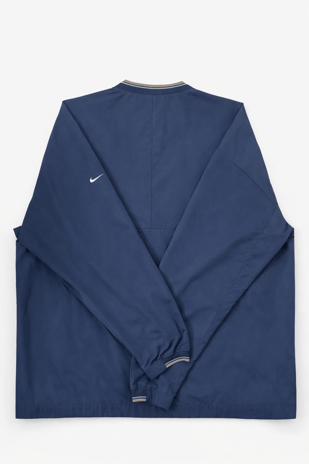 Folded navy blue jacket with a Nike logo on a white background
