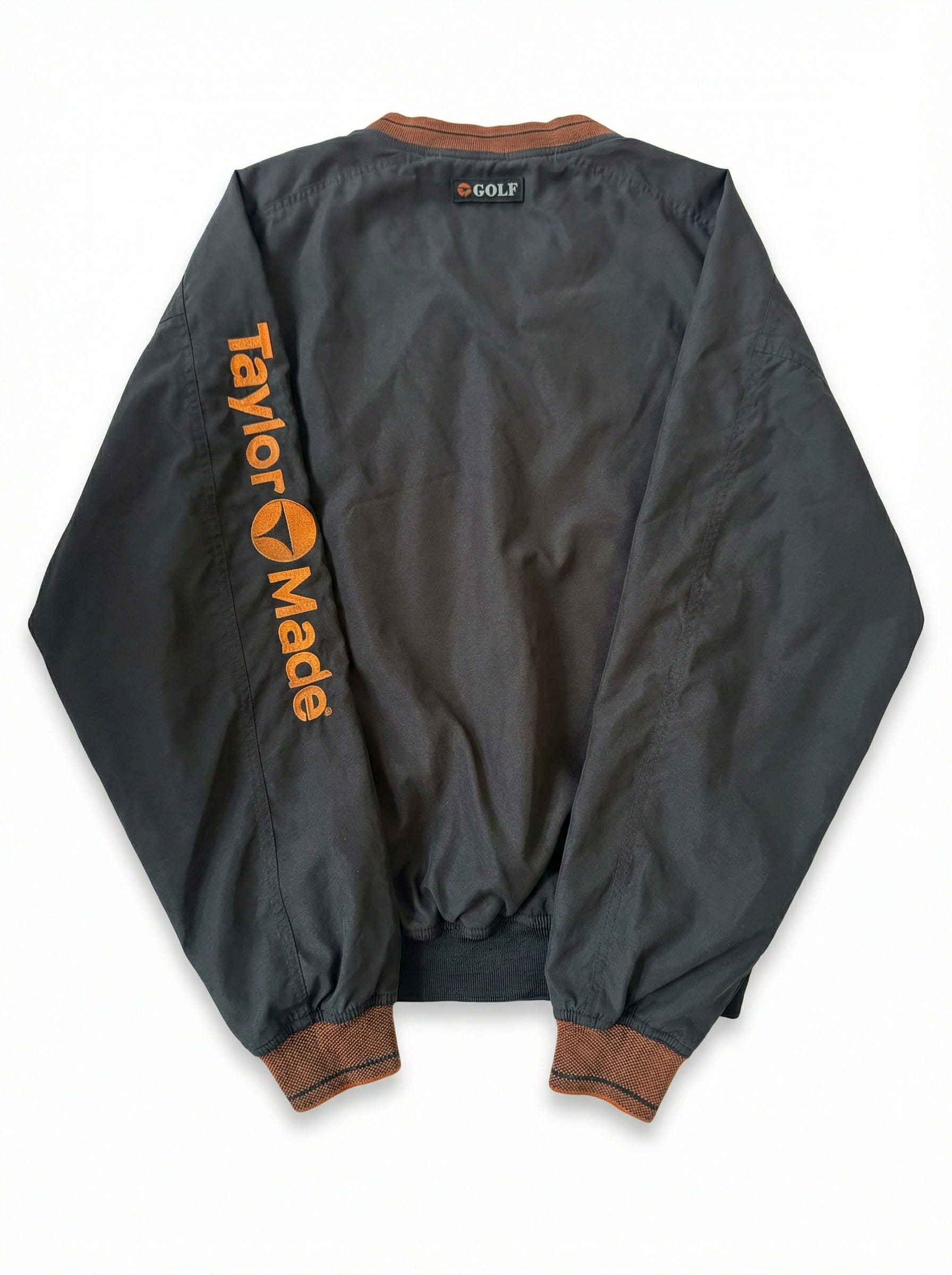 Gray jacket with 'Taylor Made' branding on the back, displayed against a white background.