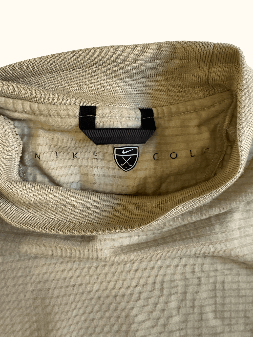 Beige Nike long-sleeve mock neck shirt label