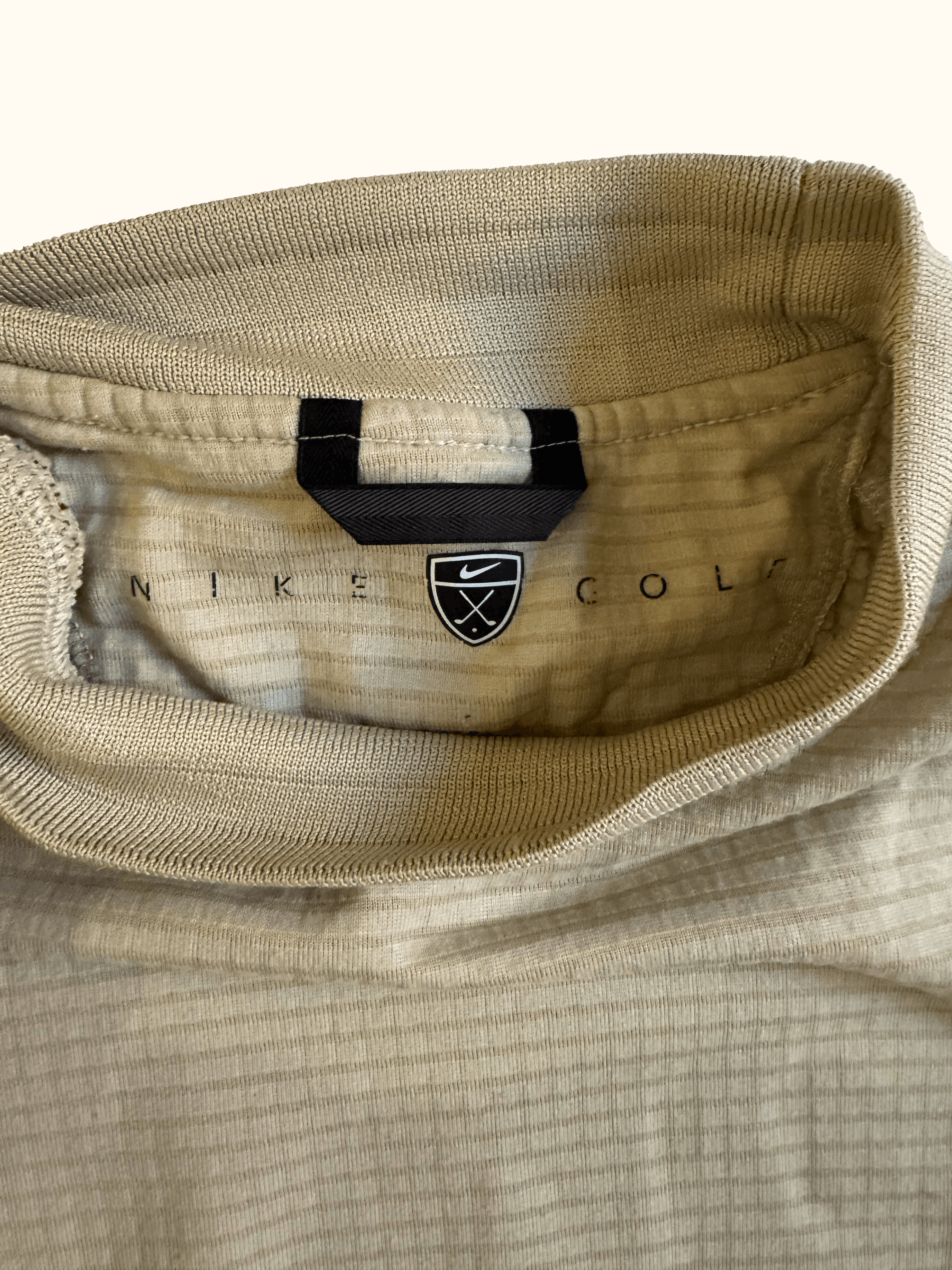 Beige Nike long-sleeve mock neck shirt label